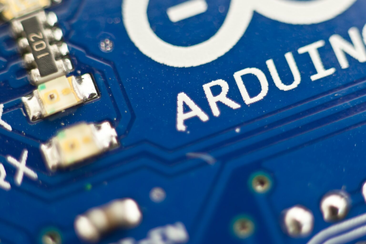a close up of a blue electronic circuit board